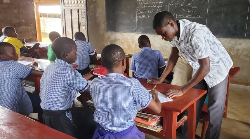P7 teacher helping students.jpg