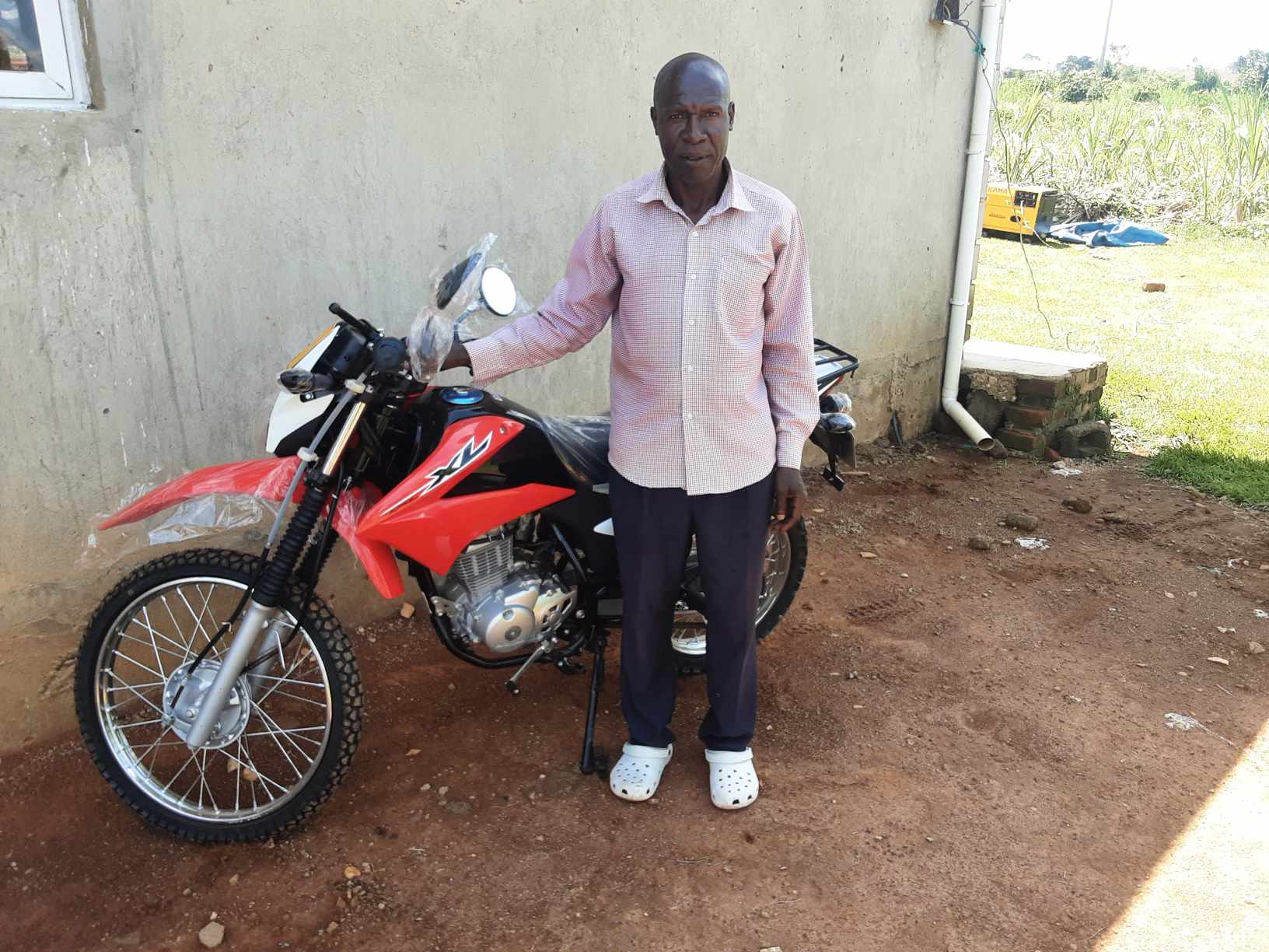 Pastor Sosan with His Brand-New Motorcycle (an earlier moment in his ministry journey)